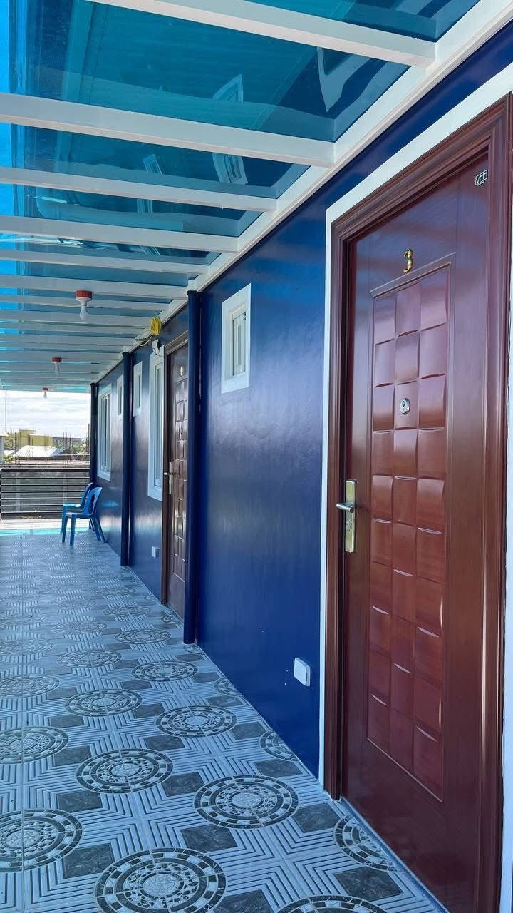Covered upper walkway at Vite Residences with numbered room doors.