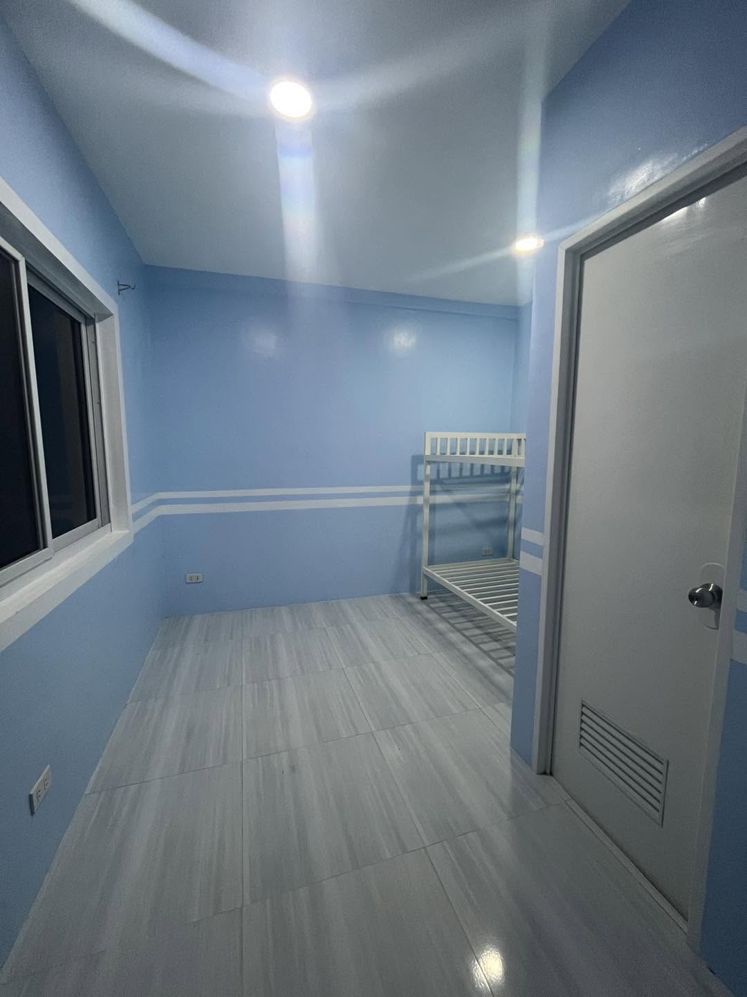 Bright room with a bunk bed and a large window.